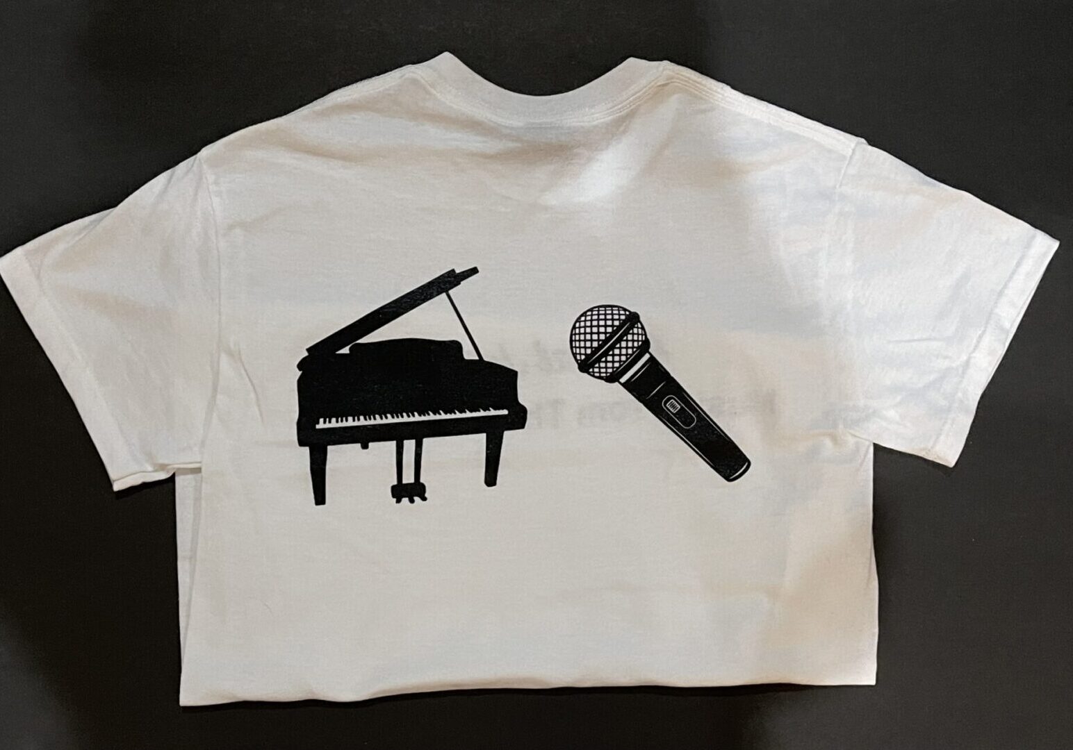 A t-shirt with a piano and microphone on it.