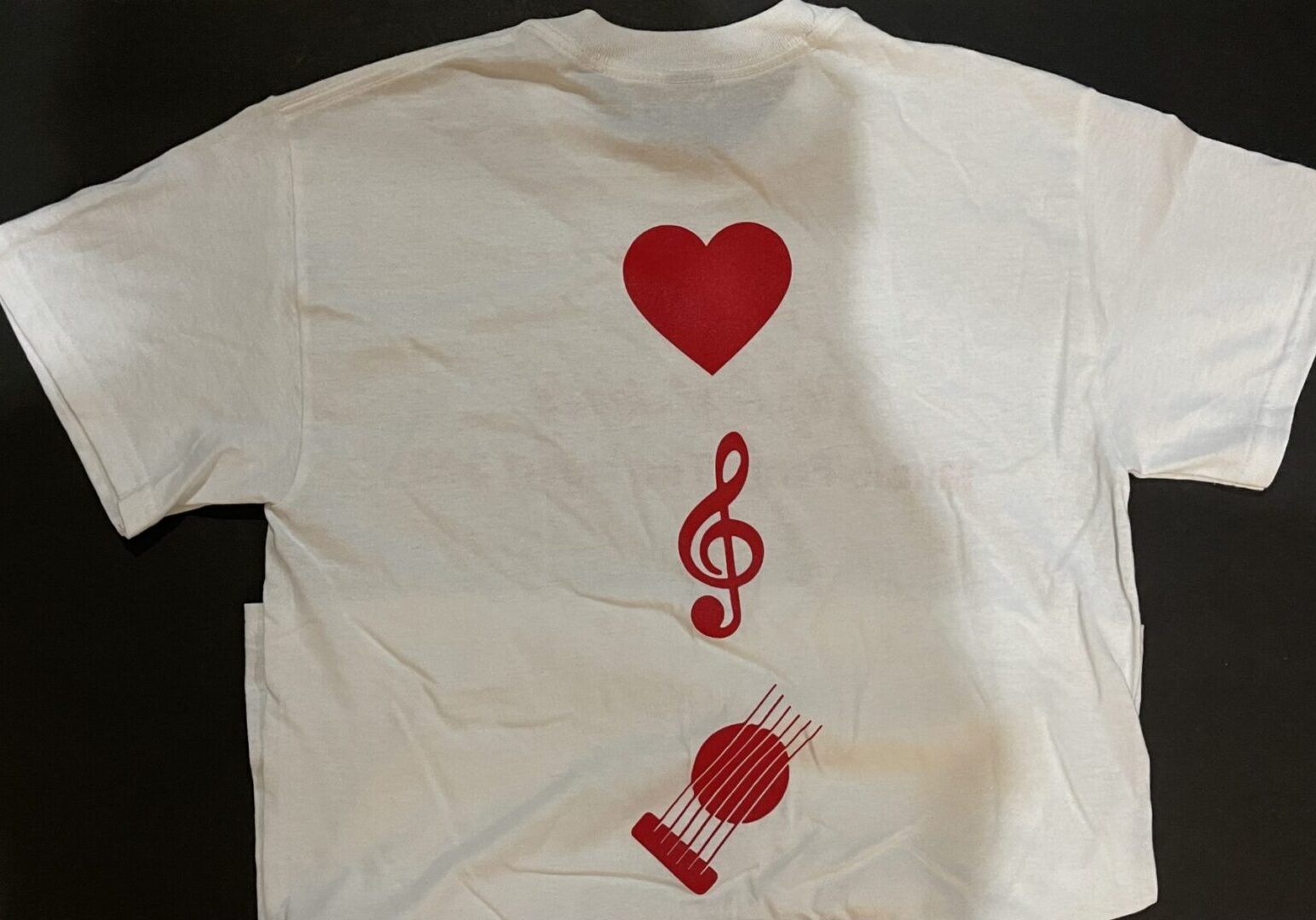 A white t-shirt with red designs on it.