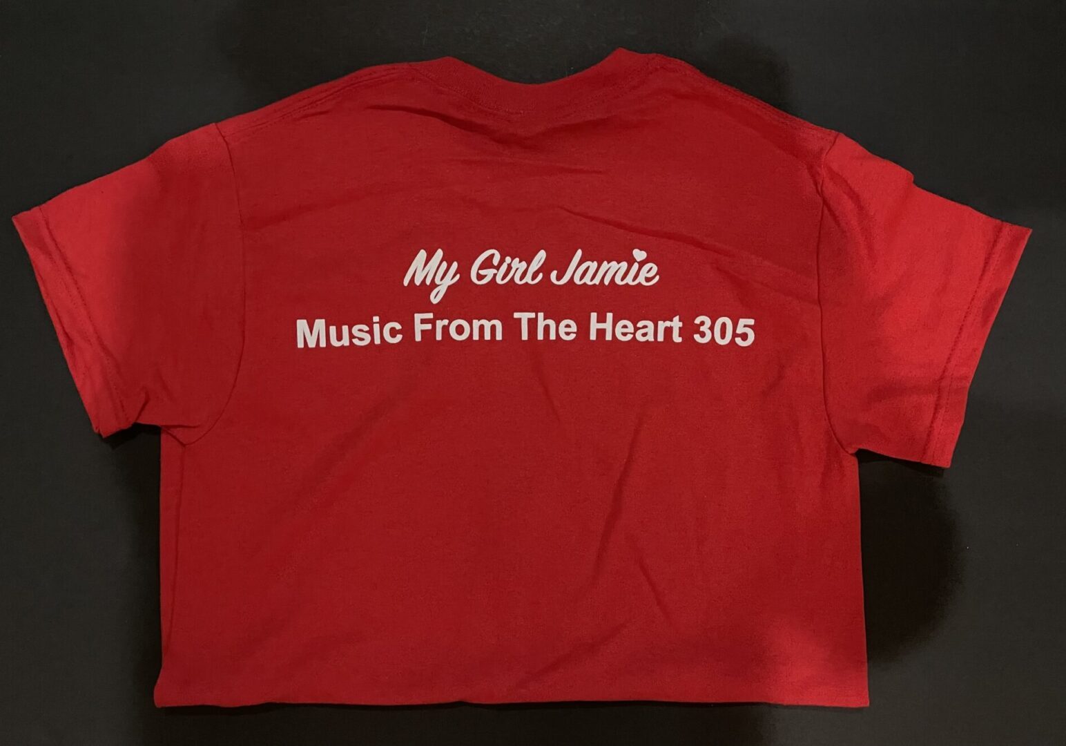 A red shirt with the words " my girl jamie music from the heart 3 0 5 ".